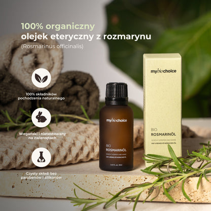 Olejek rozmarynowy mybiochoice na tle ręczników i rozmarynu, z informacjami o składzie i pochodzeniu.